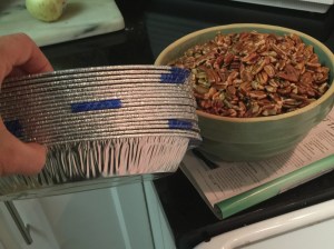Washed and toasted pecans meet a stack of Piggly Wiggly pie tins!